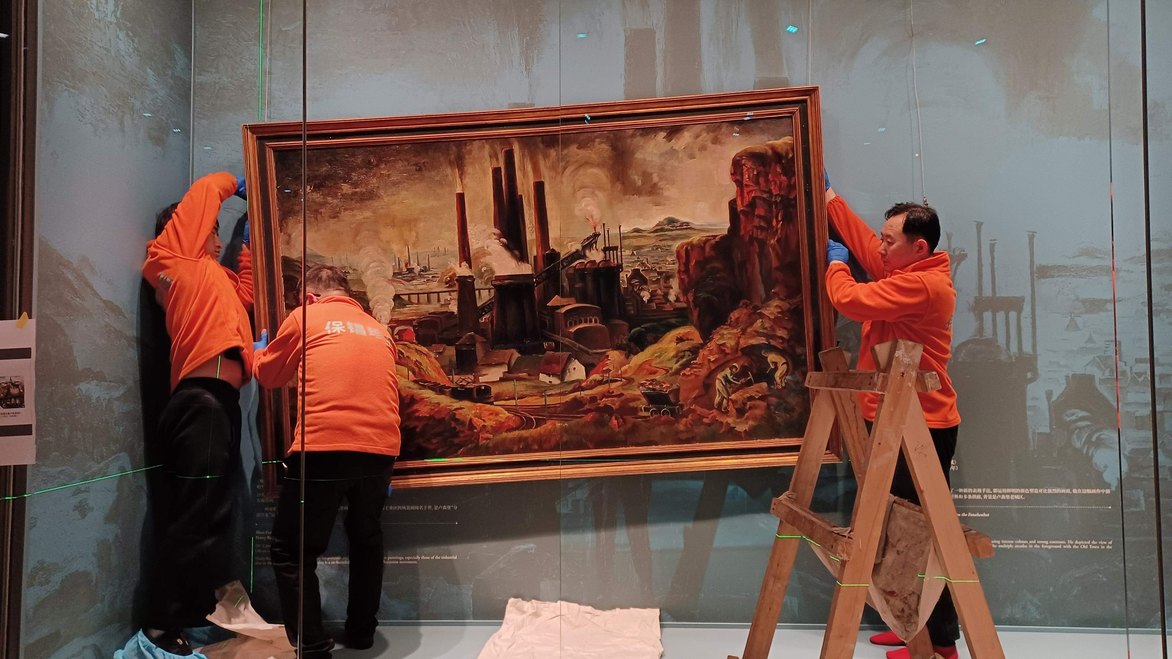 Chinese specialists ensure that the exhibits are hung correctly at the Henan Museum in in Zhengzhou