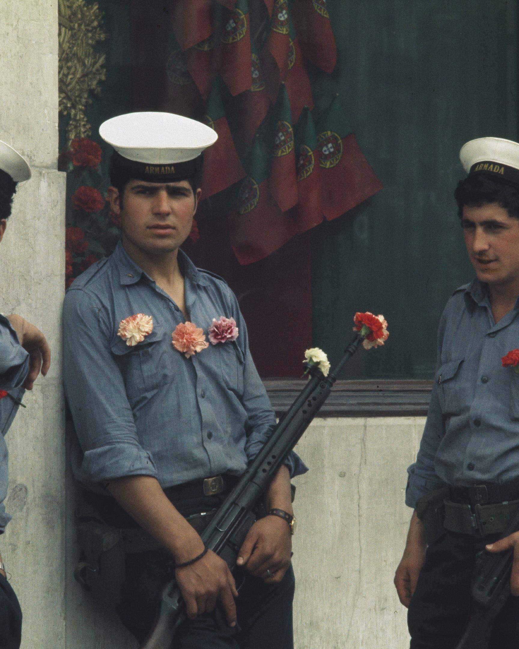 Portuguese soldiers with carnations on their uniforms and in their gun barrels stand guard in Lisbon on April 29th, 1974. The carnation is a symbol of the 'Carnation Revolution' military coup that ended nearly 50 years of dictatorship in Portugal. (Photo by UPI/Bettmann Archive/Getty Images)