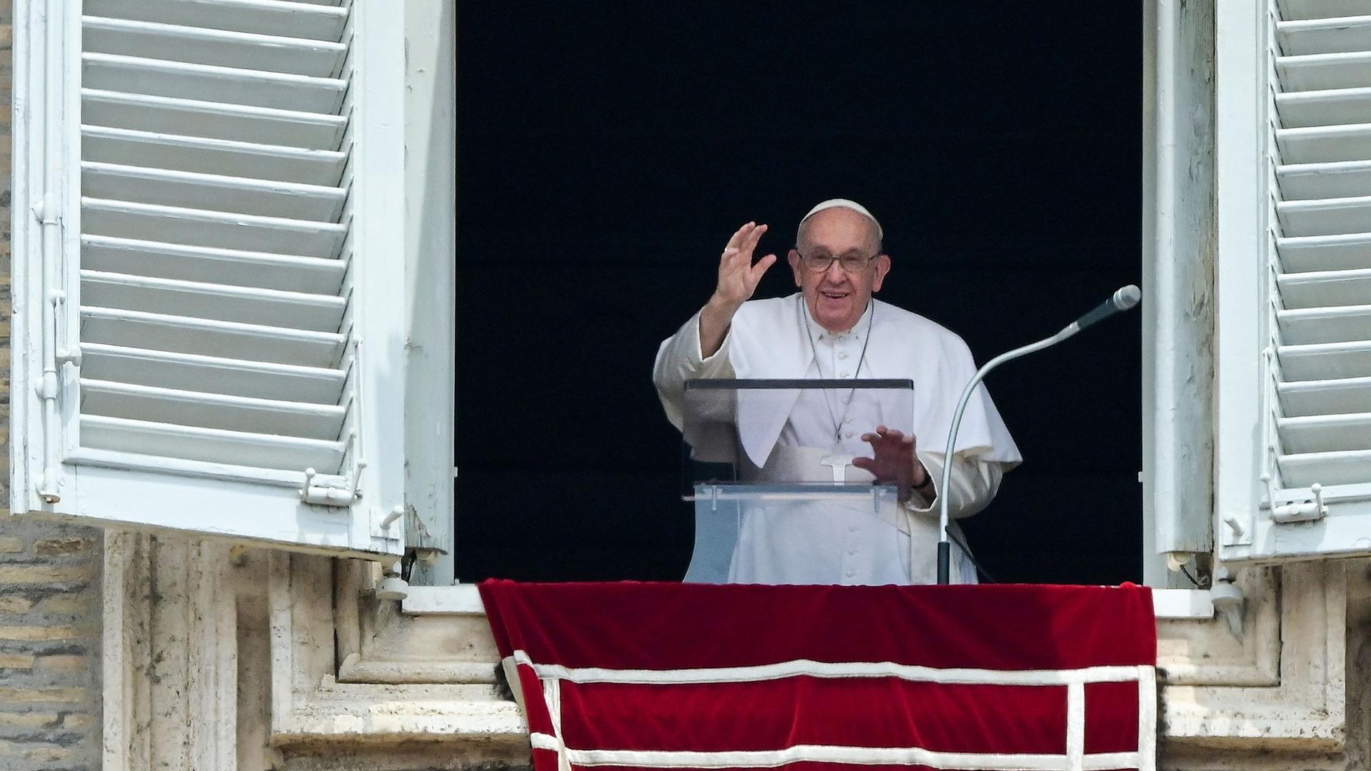 Pope Francis waves from the window of the apostolic palace overlooking St. Peter's square during the weekly Angelus prayer on June 4, 2023 in The Vatican. (Photo by Vincenzo PINTO / AFP)