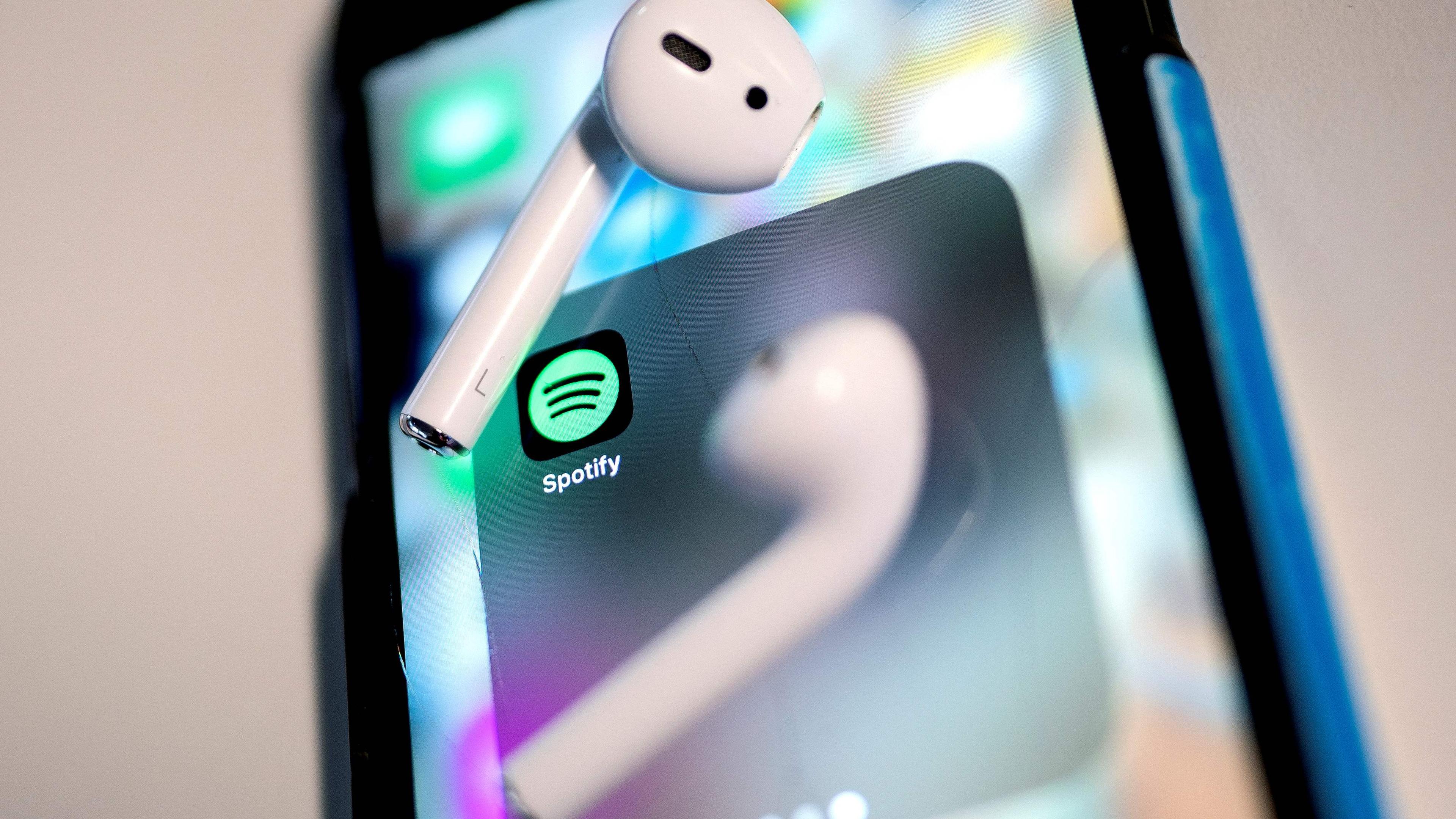 (FILES) This illustration photo shows the Spotify logo on a smartphone in Washington, DC, on January 31, 2022. Music streaming giant Spotify said on December 4, 2023 that it will reduce the number of its employees by around 17% in a bid to cut costs amid "dramatically" slower economic growth. Spotify in October posted a rare quarterly operating profit of 32 million euros, compared to a loss of 228 million for the same period a year earlier, on the back of 26% growth in active users for the third quarter. (Photo by Stefani Reynolds / AFP)