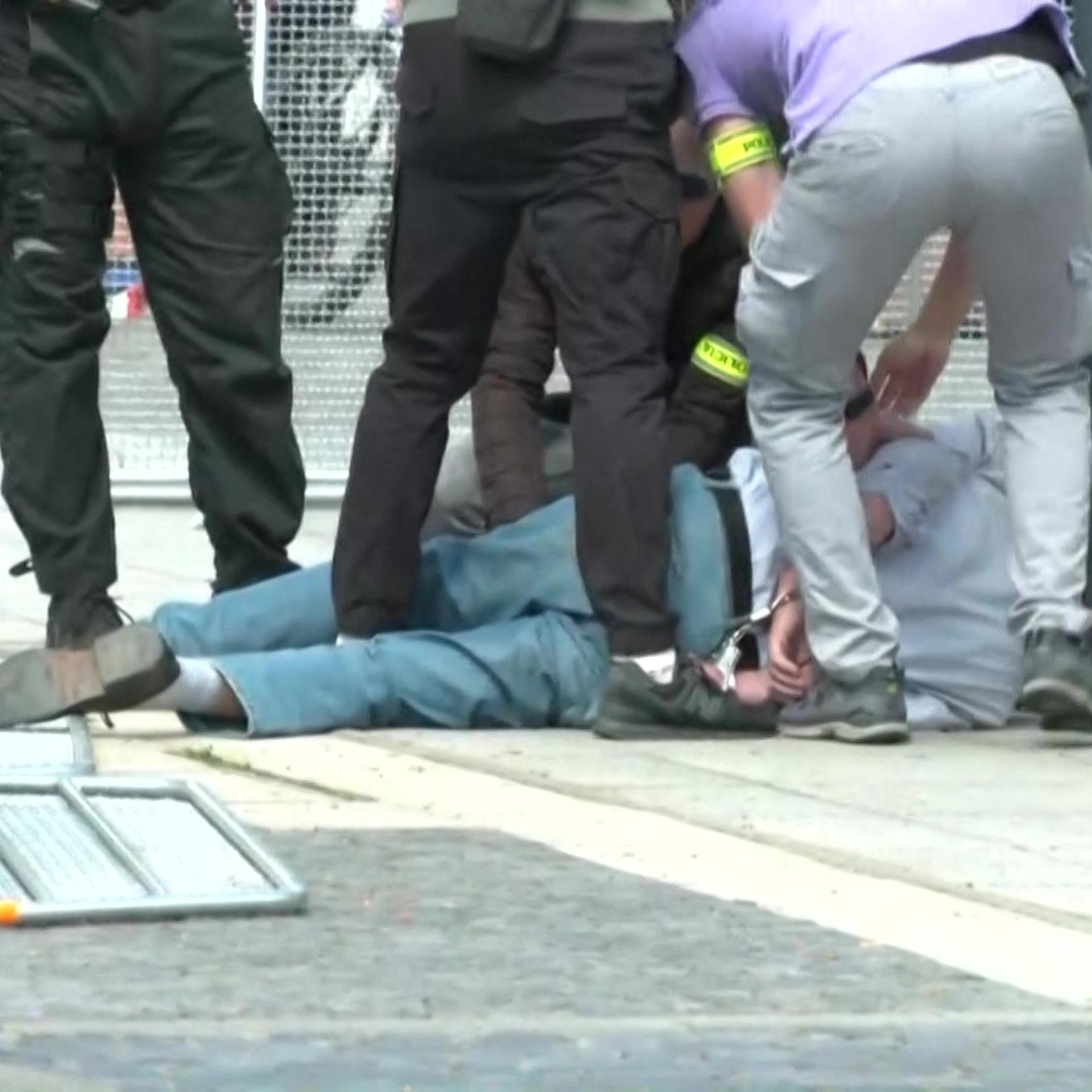 This image taken from video footage obtained by AFPTV shows security personnel apprehending a suspected gunman after Slovakia's Prime Minister was shot in Handlova on May 15, 2024