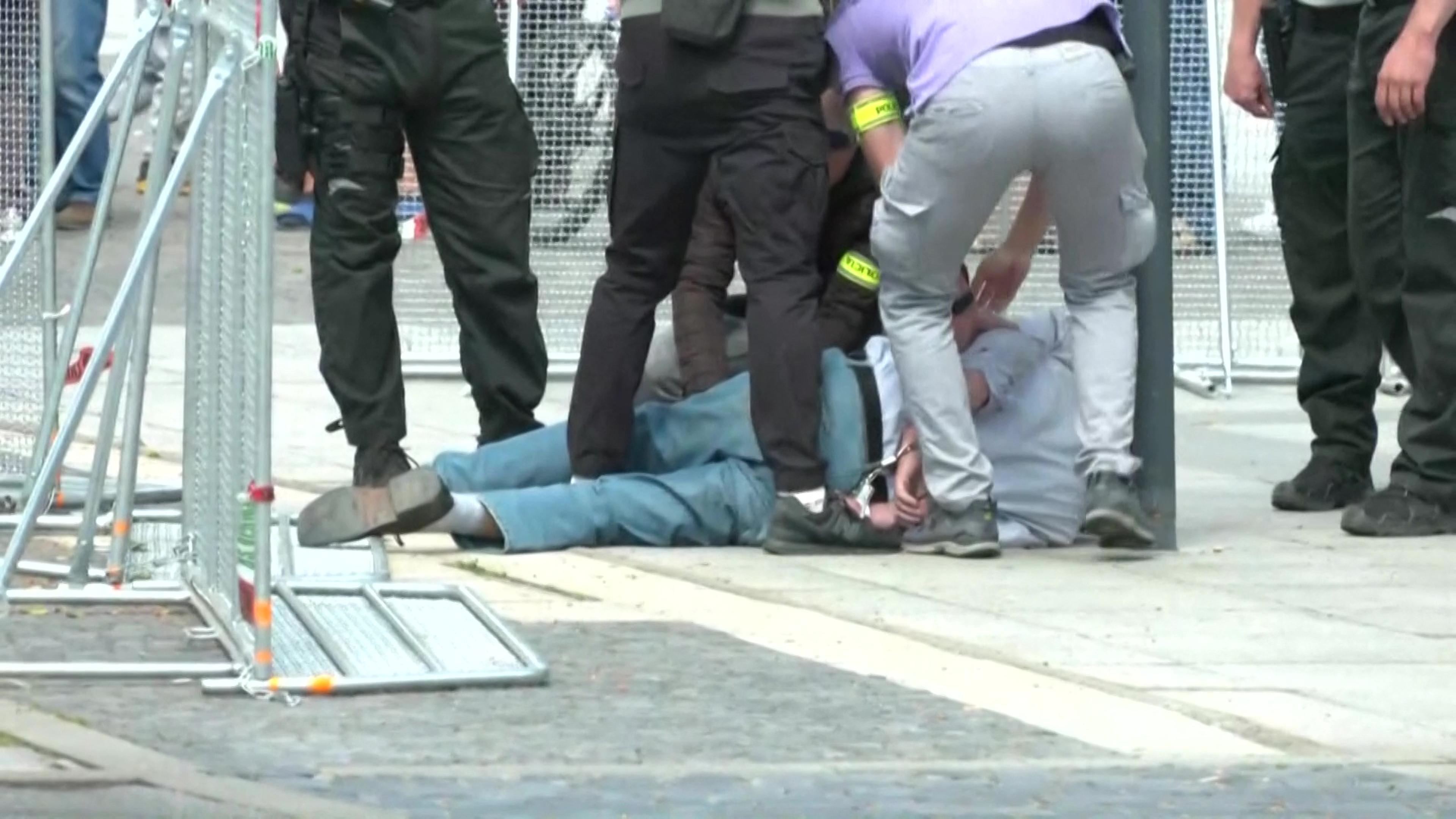 This image taken from video footage obtained by AFPTV shows security personnel apprehending a suspected gunman after Slovakia's Prime Minister was shot in Handlova on May 15, 2024