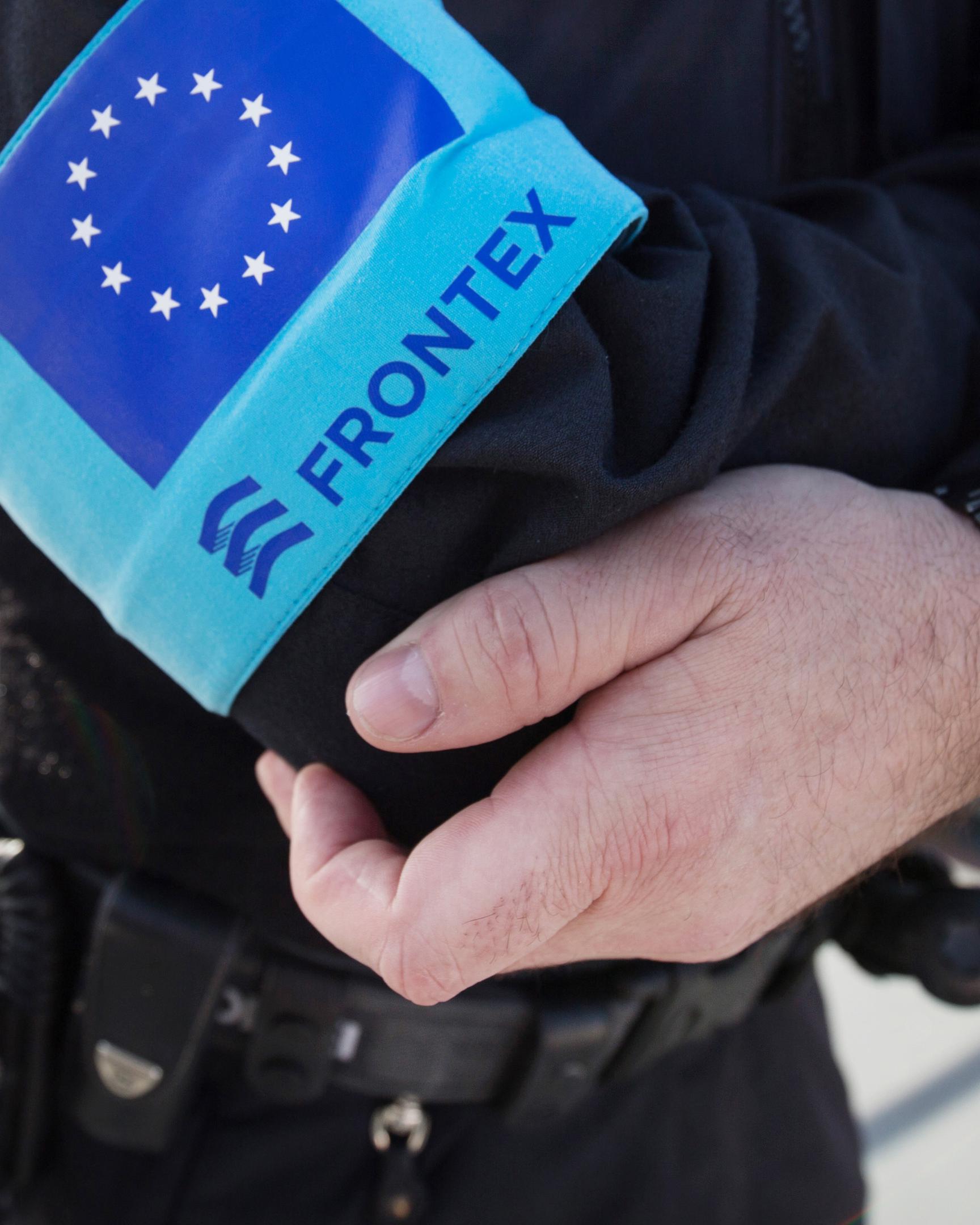 Ein Polizist der EU-Grenzschutzagentur Frontex steht im Hafen der Insel Samos auf dem Vordeck eines Streifenboots vor einer Erkundungsfahrt. Künftig sollen die Mitarbeiter auch in Belgien tätig werden.