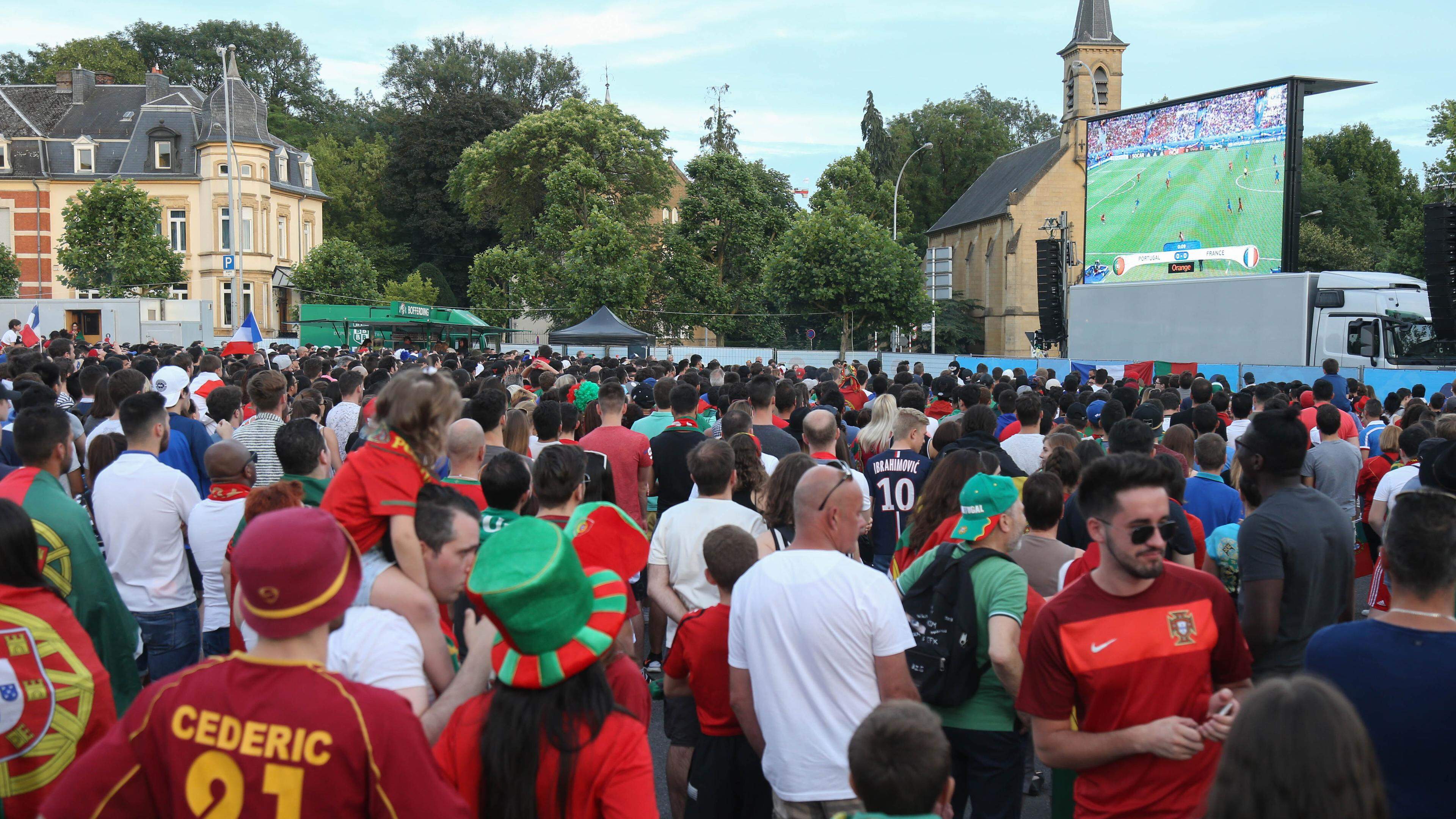 Fans attending the screening of the Euro 2016 final in the Glacis car park