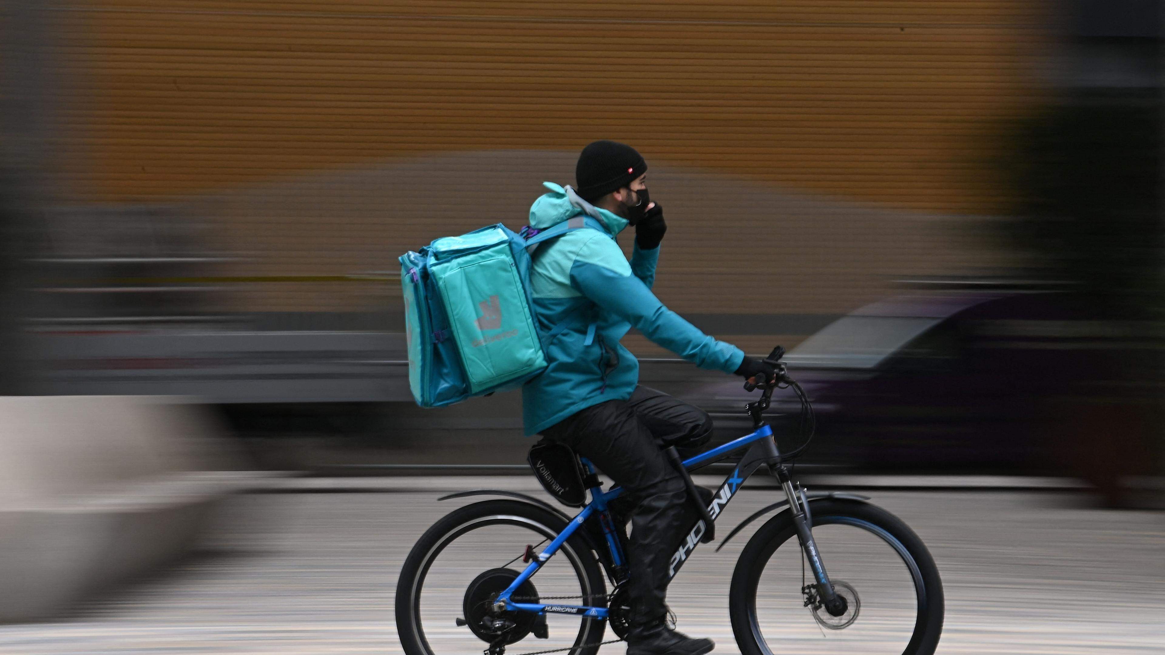 A Deliveroo rider cycles through central London, March 26, 2021.